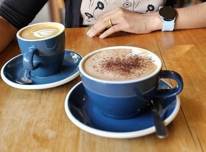 Two coffees served in Sime's Kitchen's blue ceramic cups