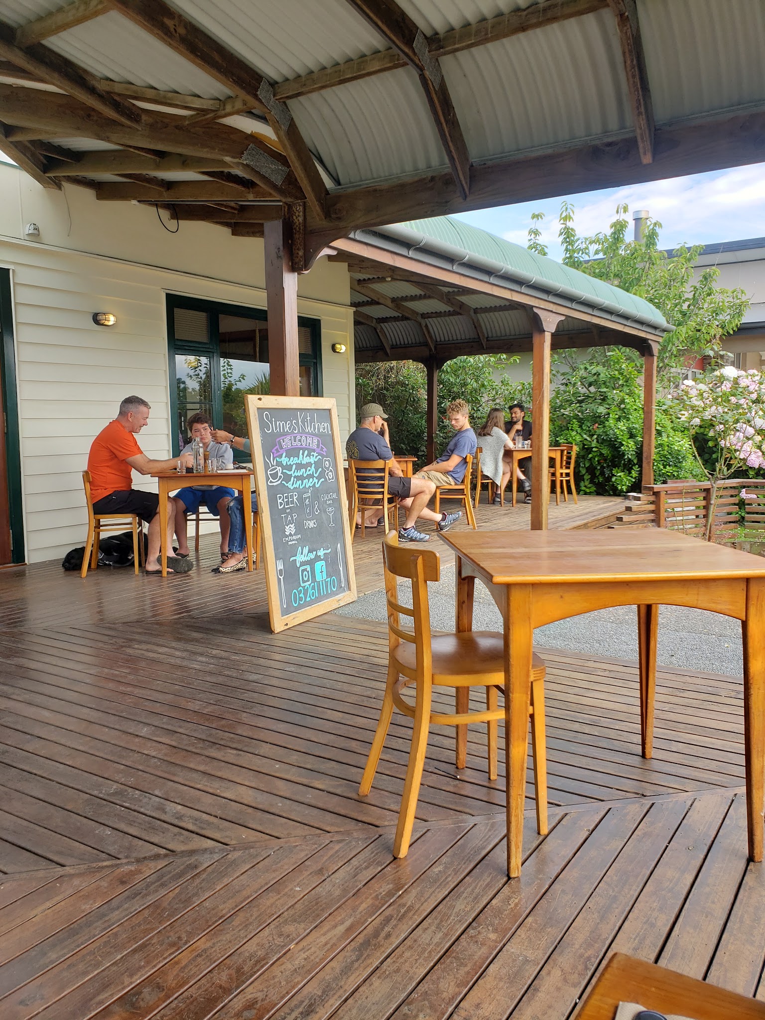 Guests seated on the covered outdoor patio at Sime's Kitchen